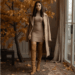 woman wearing camel colored dress with knee high boots and long coat