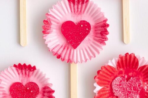 Valentine’s Day craft made with cupcake liners, heart cutouts, and popsicle sticks