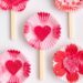 Valentine’s Day craft made with cupcake liners, heart cutouts, and popsicle sticks