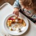 toddler refuses dinner with half eaten plate of food