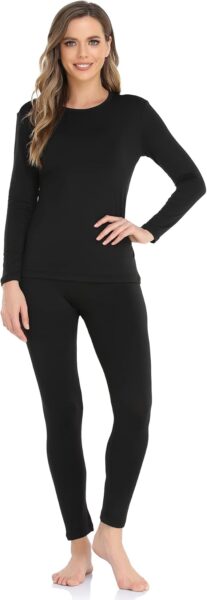 Woman wearing black long sleeve thermal shirt and pants to stay warm in winter.