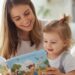 Mom playing with her 3-year-old toddler at home, reading a book and enjoying a calm, cheerful moment together.